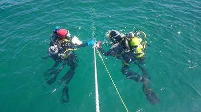 Diving archaeologists waiting at the anchor for permission to descend.